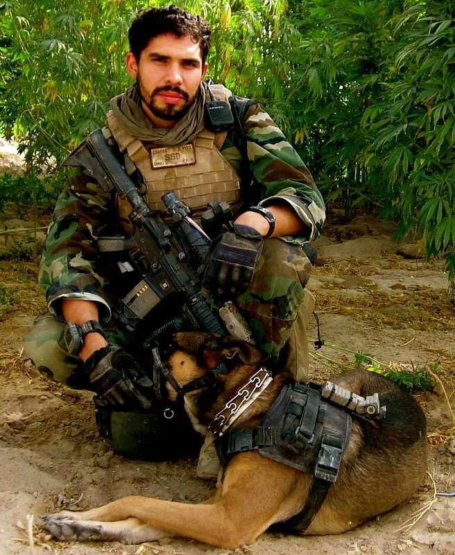 A deployed service member in combat gear in the field