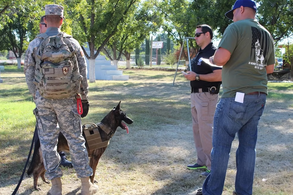 A K9 handler with a working dog at an outdoor event