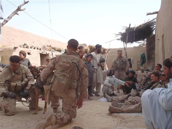 Service members with a working dog during an overseas deployment