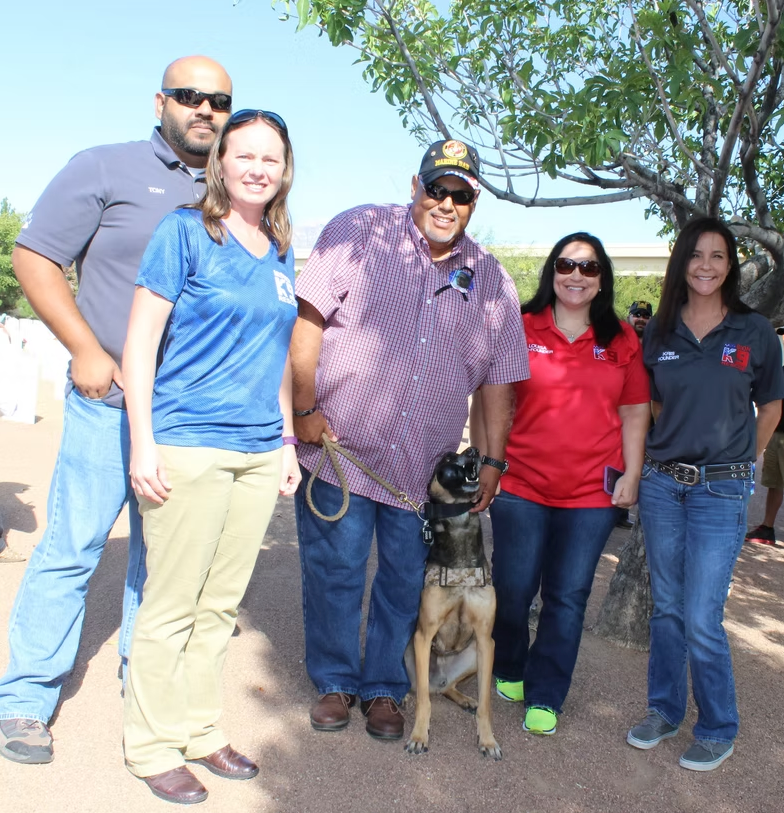 Volunteers and supporters with working dogs at a fundraising event