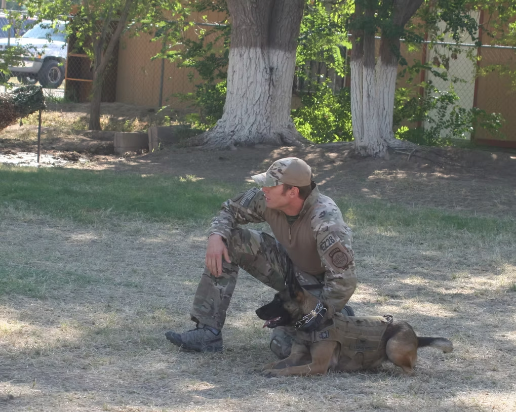 A U.S. Marine kneeling in the field during deployment